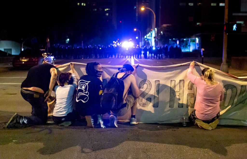 Second Place, Chuck Scott Student Photographer of the Year - Michael Blackshire / Ohio UniversityProtesters duck for cover under a sign as Louisville police use tear gas to disperse protests in downtown Louisville on May 29th, 2020. The protest was sparked by the death of George Floyd and the officer-involved shooting death of Breonna Taylor.