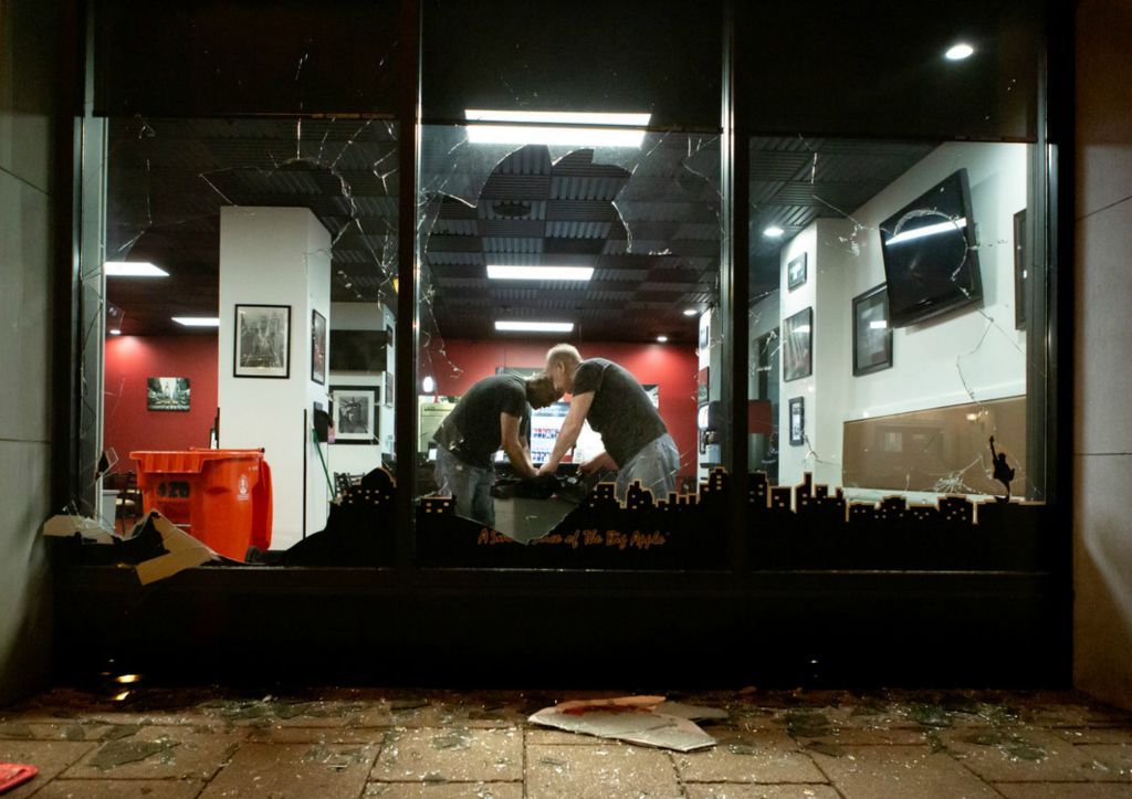 Second Place, Chuck Scott Student Photographer of the Year - Michael Blackshire / Ohio UniversityEmployees work in the middle of the night to pick up and clean damage done to the Manhattan Grill in downtown Louisville on May 29th, 2020. One of the managers of the restaurant walked in to find two shattered windows. “What’s the reason for this?” the manager said. “Both windows and the door, look at this!” 