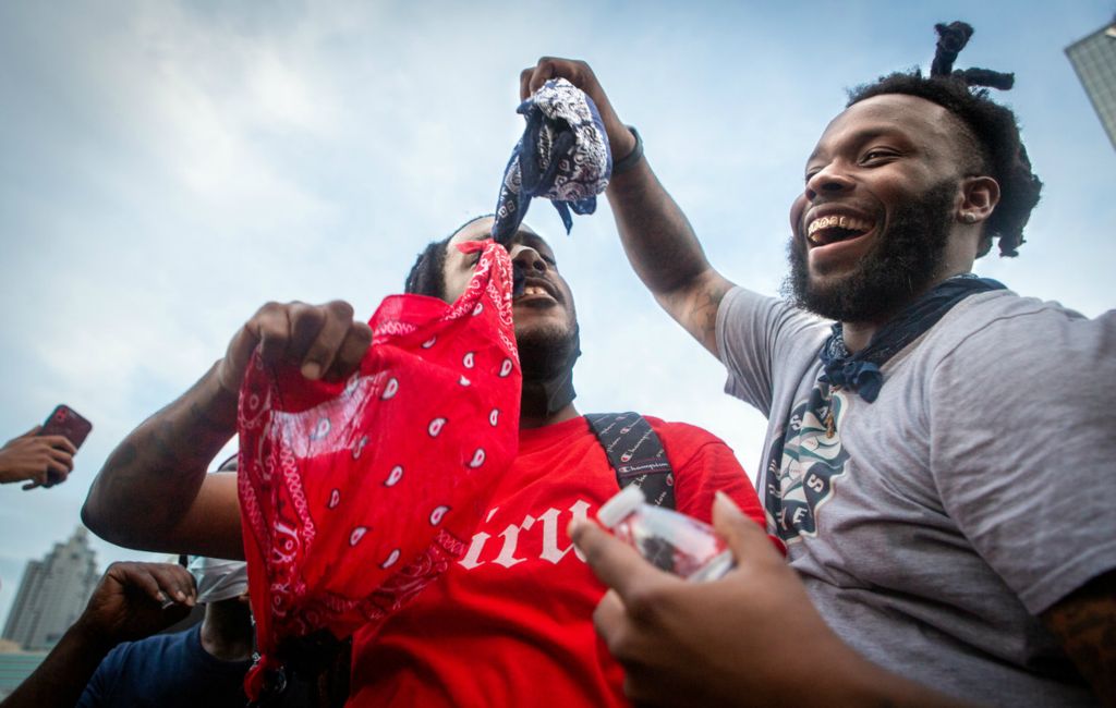 Second Place, Chuck Scott Student Photographer of the Year - Michael Blackshire / Ohio UniversityRival gang members hold up opposing gang flags tied together in solidarity during massive protests in downtown Atlanta after the death of George Floyd on June 3, 2020. The protest of Rayshard Brooks, Breonna Taylor, and Ahmaud Arbery would soon become a memory and life moved on. Black people wondered when the story would happen again, until it did in Kenosha a little over two months later. 