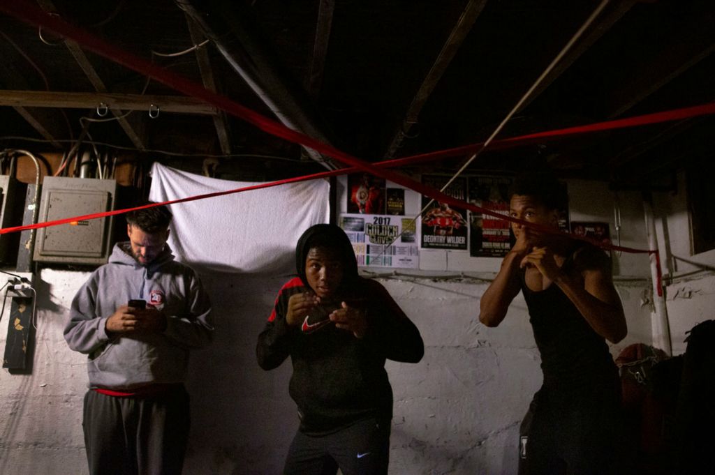 Second Place, Chuck Scott Student Photographer of the Year - Michael Blackshire / Ohio UniversityDemontaze Duncan, 18, practices in Coach Nick’s basement in Louisville. Duncan lives with Coach Nick, who is both his trainer and guardian on October 13, 2020.