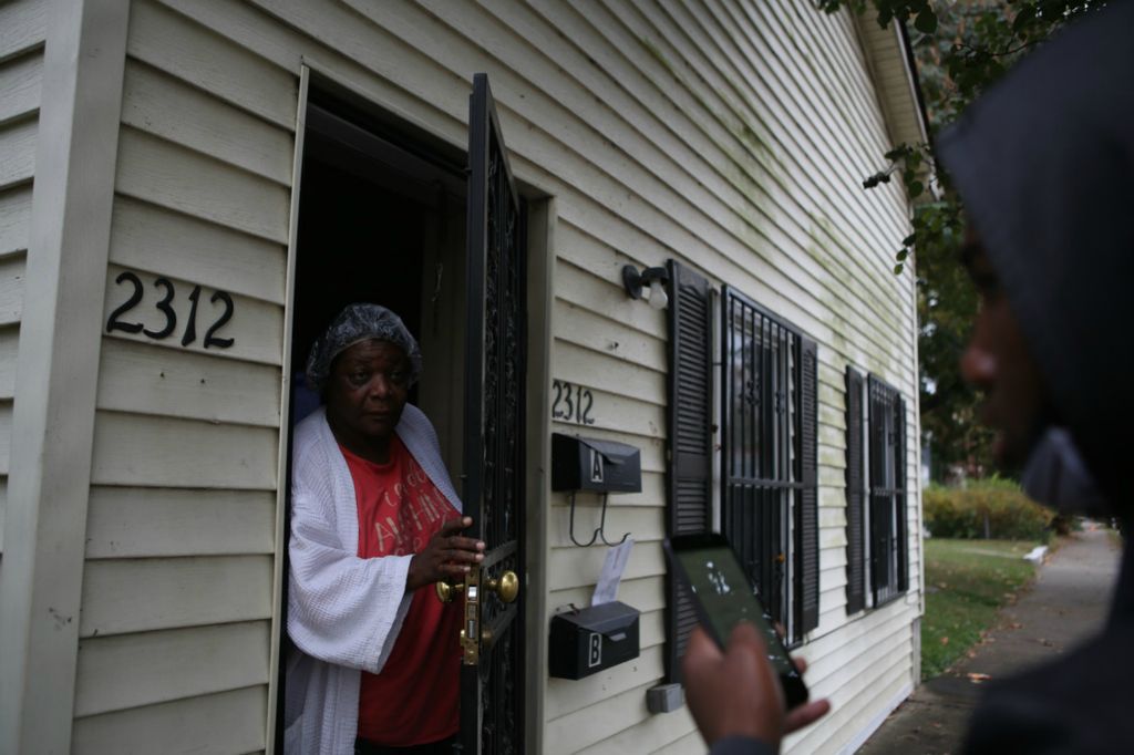 Second Place, Chuck Scott Student Photographer of the Year - Michael Blackshire / Ohio UniversityDemontaze Duncan, 18, does polling for Amy McGrath and talks to Rita in the Westend of Louisville on October 18, 2020.