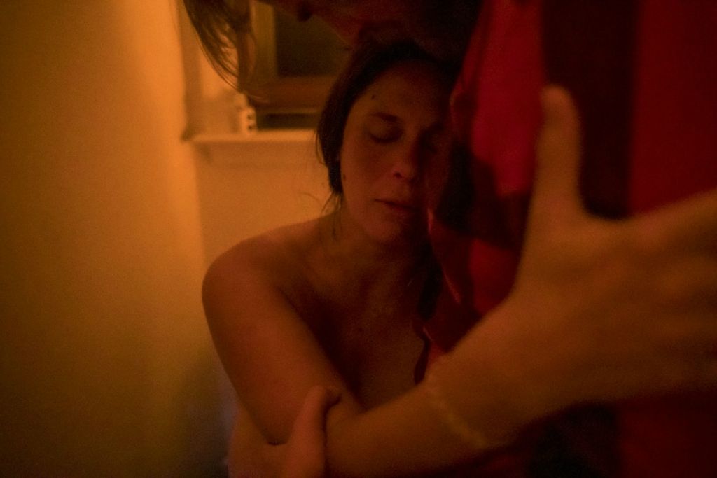 Third Place, Chuck Scott Student Photographer of the Year - Lauren Santucci / Ohio University10:05pm: Just after getting out of the birthing pool, Kate labors while sitting on the toilet in her bathroom.