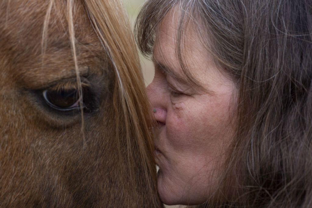 Third Place, Chuck Scott Student Photographer of the Year - Lauren Santucci / Ohio UniversityVickie Seiter kisses one of her horses, Popcorn, after feeding him. Vickie moved to Chesterhill four years ago to fulfill her dream of starting a life-coach business where she uses horses to support her clients. “This is my church,” Vickie says about her small horse farm. 