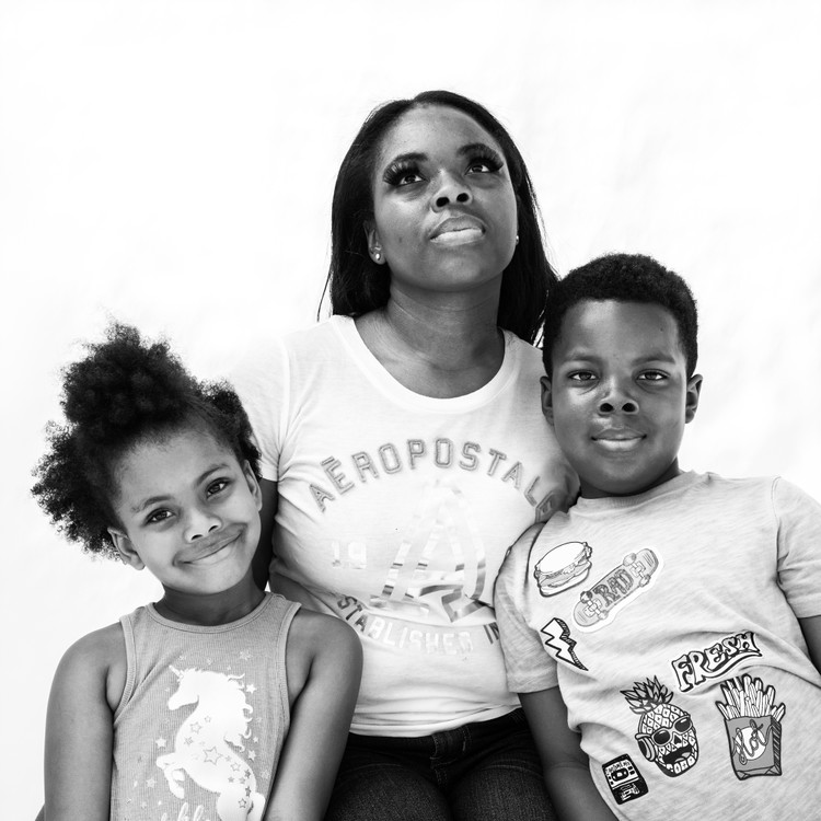 Third Place, Feature Picture Story - Joshua A. Bickel / The Columbus Dispatch, “Lifting Their Voices”Nitoriya Goff, 32, Faith Smith, 4, and Isaiah Smith, 6, of Columbus, Ohio:Nitoriya Goff and her two children –– 6-year-old Isaiah and 4-year-old Faith –– are just a piece of what she calls her “huge bonded, blended and unbroken family.”“We are a tribe,” Goff said. “My nieces and nephews are mixed. We’ve got family from all over.”When she looks out at the crowds of protesters, she sees a reflection of her family. People of all different backgrounds, united together by a common bond. It’s for that reason, she said, she feels hopeful.“Change is coming,” Goff said. “My kids are gonna be safer and they’re gonna have more to look forward to.”She paused, opened her eyes and looked heavenward.“Thank you, God,” she said.