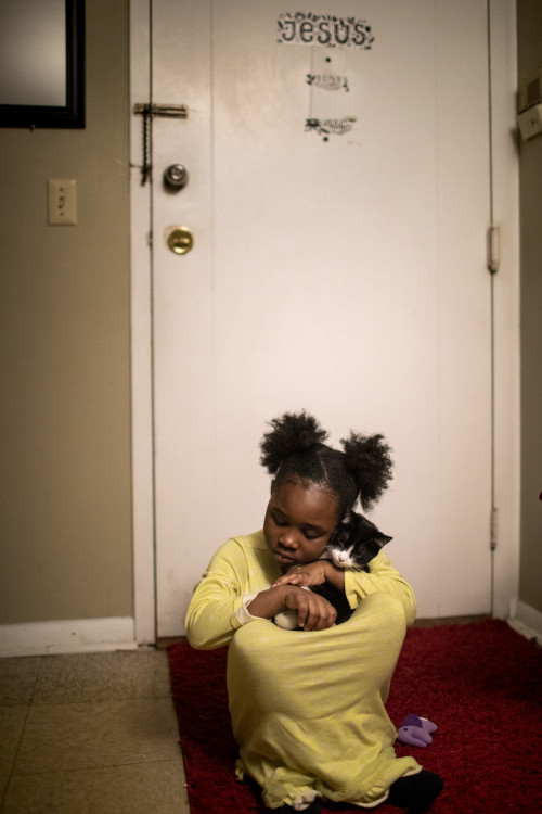 Award of Excellence, Feature Picture Story - Meg Vogel / The Cincinnati Enquirer, “Renters”Angelina, 7, snuggles her cat, Bobo, before bedtime on Wednesday, February 26, 2020 in Westwood.  Page Berry's daughters have asked for a pet for years. She could finally get the 4-month-old kitten because the apartment complex didn't charge for pets.