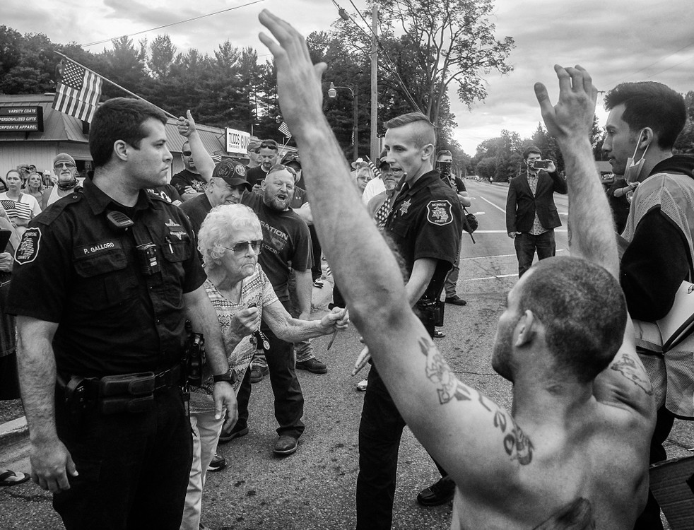 Award of Excellence, General News - Jeremy Wadsworth / The Blade, “Todd’s Guns”Monroe County Sheriff’s deputies separate Black Lives Matter protesters (right) from counter protesters during a protest calling for the removal of Bedford Schools Board member Todd Bruning, who has been criticized for social media posts that have been described to be anti-Muslim, anti-LGBTQ, misogynistic, and racist June 12, 2020, at Mr. Bruning’s business, Todd’s Guns, in Lambertville, Michigan.