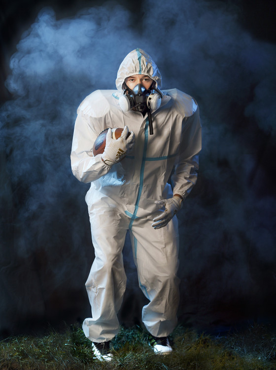 Second Place, Issue Illustration - Daniel Melograna / The Daily Standard, “Hazmat Football”New Bremen running back Wyatt Dicke wears a disposable hazmat suit and ventilation mask to illustrate playing sports in the COVID-19 era. Gov. Mike Dewine announced that school officials can decide if and when their athletes will compete.