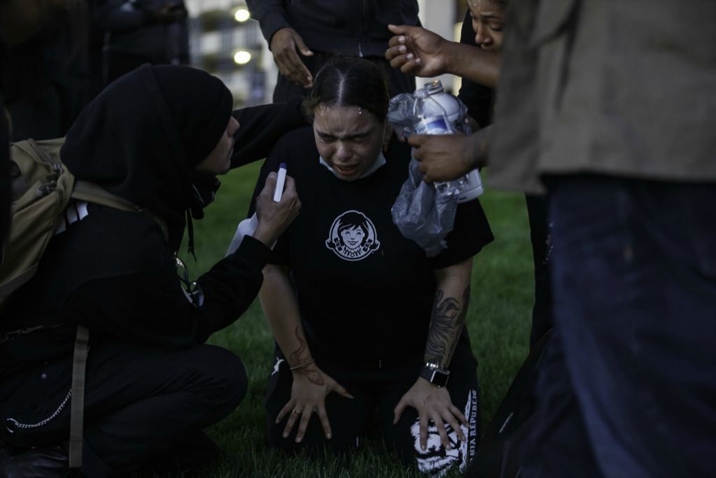 Second Place, News Picture Story - Joshua A. Bickel / The Columbus Dispatch, “George Floyd Protests”A women kneels to the ground as others tend to her after she was pepper sprayed during nationwide protests following the death of George Floyd on Friday, May 29, 2020 in Columbus, Ohio.