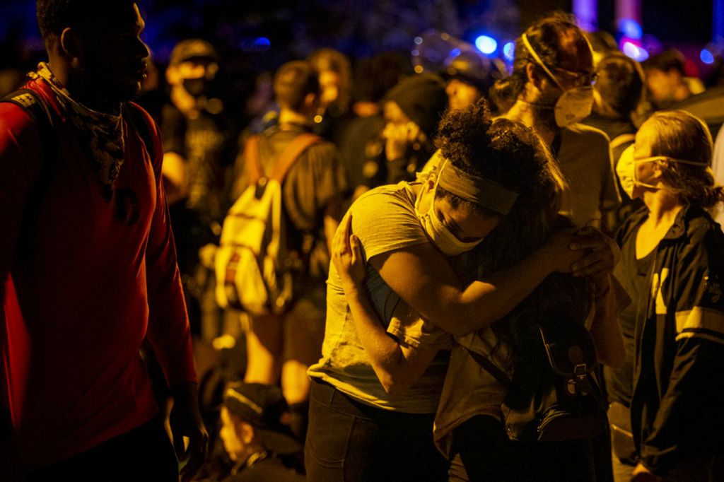 Award of Excellence, News Picture Story - Meg Vogel / The Cincinnati Enquirer, “BLM Protest”Protesters embrace before being arrested on Green Street in Over-the-Rhine on Sunday, May 31, 2020. This is the third night of protests in response to the death of George Floyd in Minneapolis.