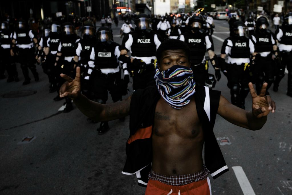 First Place, James R. Gordon Ohio Understanding Award - Joshua A. Bickel / The Columbus Dispatch, “Political Climate of Southeast Ohio”A protester walks down Broad Street as Columbus Division of Police officers walk behind during nationwide protests following the death of George Floyd on Friday, May 29, 2020 in Columbus, Ohio. Floyd, a 46-year-old Black man, was killed while in police custody after allegedly passing a counterfeit $20 bill at a convenience store. Derek Chauvin, one of four Minneapolis police officers involved in Floyd's arrest, has himself been arrested and charged with third-degree murder and manslaughter. During the arrest, video footage showed Chauvin kneeling on Floyd's neck for almost nine minutes as Floyd repeatedly said "I can't breathe."