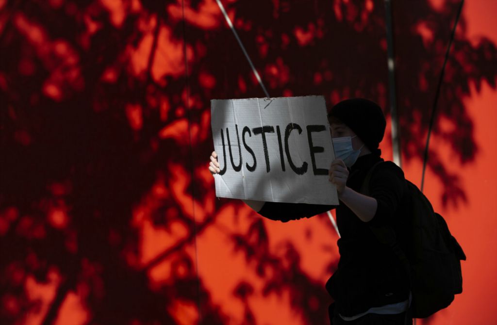 First Place, James R. Gordon Ohio Understanding Award - Adam Cairns / The Columbus Dispatch, “Political Climate of Southeast Ohio”A 20-year-old protester from the West Side holds a sign that says "justice" as they march north on High Street during a peaceful protest for George Floyd in downtown Columbus on Tuesday, June 2, 2020. 