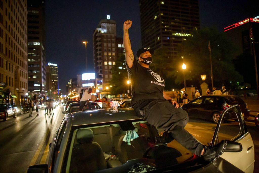 First Place, James R. Gordon Ohio Understanding Award - Adam Cairns / The Columbus Dispatch, “Political Climate of Southeast Ohio”Naasia Starks, 26, sits on the hood of her car with her fist raised as demonstrators take to the street during a protest for racial equality and justice in the wake of George Floyd's death in front of the Ohio Statehouse shortly before the 10 p.m. curfew in Columbus on Thursday, June 4, 2020. 