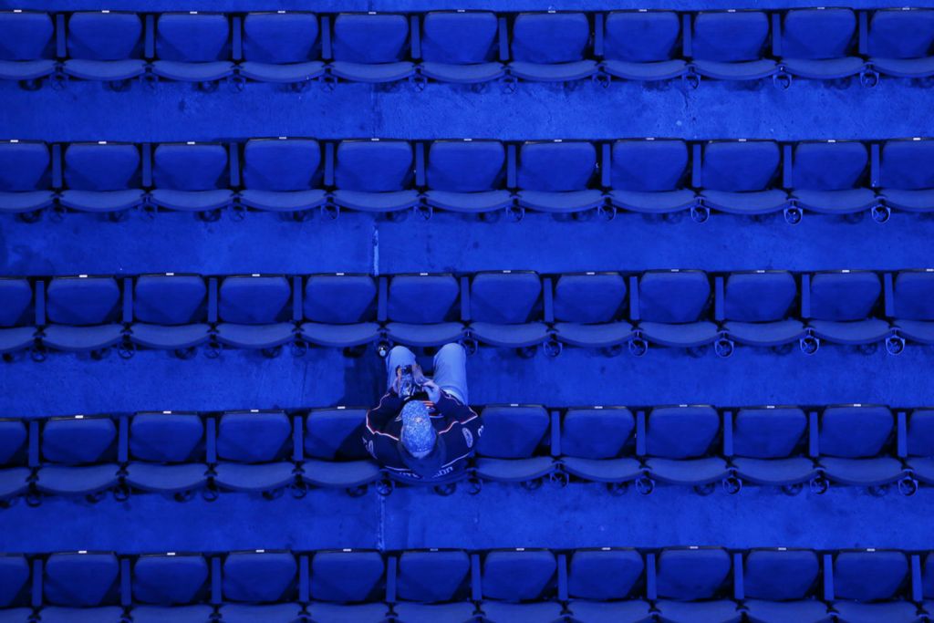 Second Place, Pictorial - Adam Cairns / The Columbus Dispatch, “Fans in Blue”A Columbus Blue Jackets waits for warm-ups prior to the NHL hockey game against the New Jersey Devils at Nationwide Arena in Columbus on Jan. 18, 2020.  