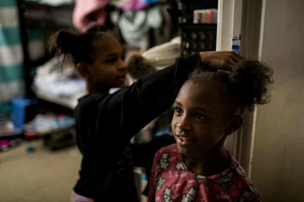 First Place, George S. Smallsreed Jr. Photographer of the Year - Large Market - Meg Vogel / The Cincinnati EnquirerAmariyonna measures Ajaunae's height on the doorframe of the bedroom of their Westwood apartment on Wednesday, February 26, 2020. The girls have been making their growth with a blue marker for months. 