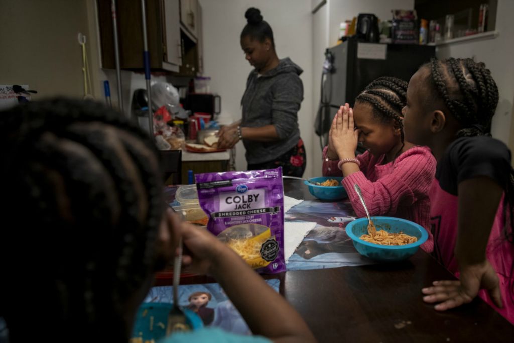First Place, George S. Smallsreed Jr. Photographer of the Year - Large Market - Meg Vogel / The Cincinnati EnquirerAmariyonna, 9, prays before eating dinner with her sisters and mom in their apartment in Westwood on Tuesday, February 4, 2020.