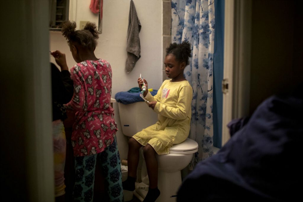 First Place, George S. Smallsreed Jr. Photographer of the Year - Large Market - Meg Vogel / The Cincinnati EnquirerAngelina, 7, puts toothpaste on her toothbrush while her sisters brush their teeth in the bathroom on Wednesday, February 26, 2020. 