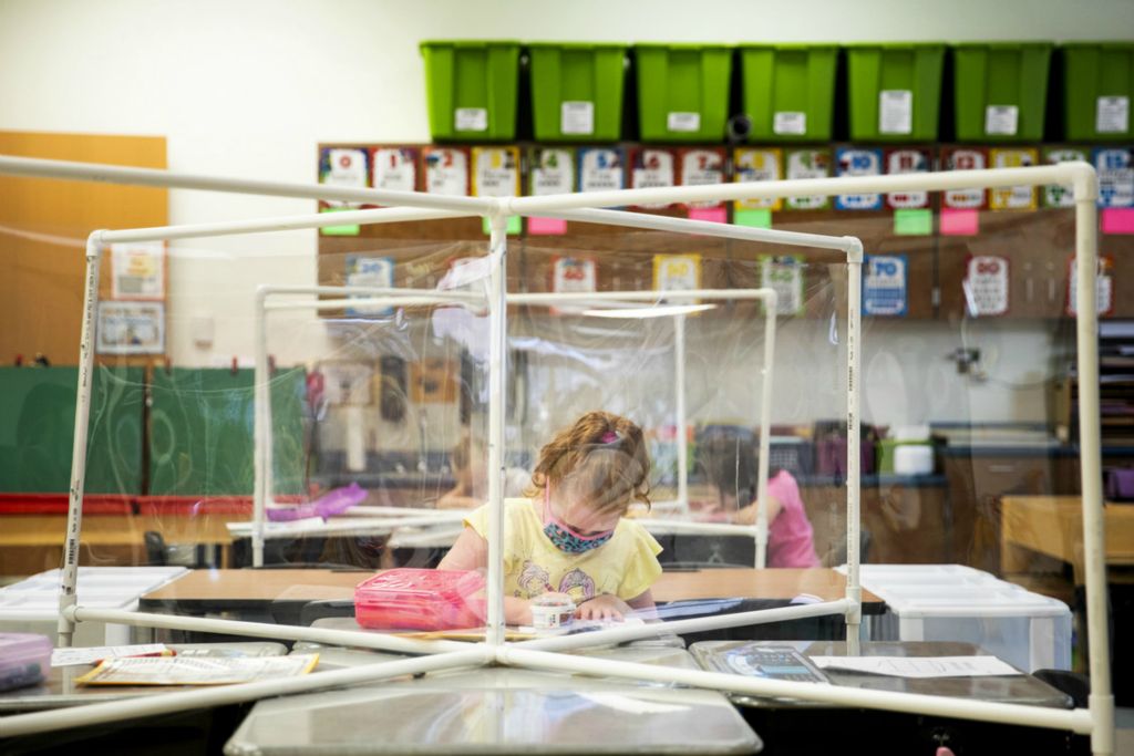 First Place, George S. Smallsreed Jr. Photographer of the Year - Large Market - Meg Vogel / The Cincinnati EnquirerKindergartner Khloe Chotrow practices her coloring in Mrs. Haas's class at Three Rivers School Elementary in Cleves on Friday, September 4, 2020. For the first week of school, students wore masks to match their new backpacks. They knew to wait at the door for their teacher to check their temperature. They talked to their classmates through plastic partitions that divided the desks. 