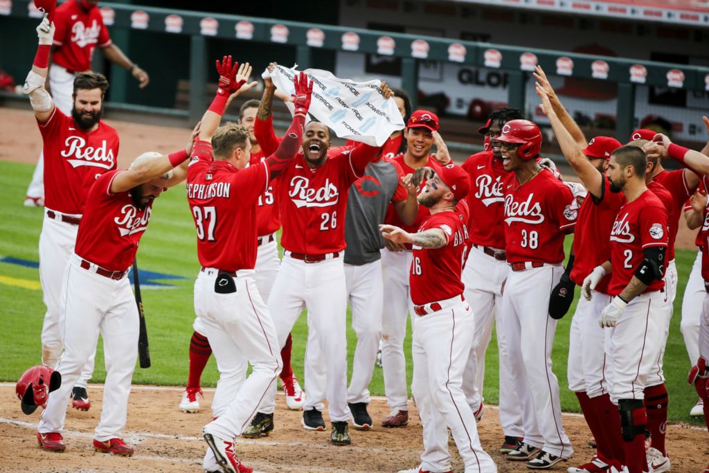 First Place, George S. Smallsreed Jr. Photographer of the Year - Large Market - Meg Vogel / The Cincinnati EnquirerCincinnati Reds pinch hitter Tyler Stephenson celebrates with his teammates after hitting a two-run home run to beat the Pittsburgh Pirates 3-1 during the day game on Monday, Sept. 14, 2020, at Great American Ball Park in Cincinnati.