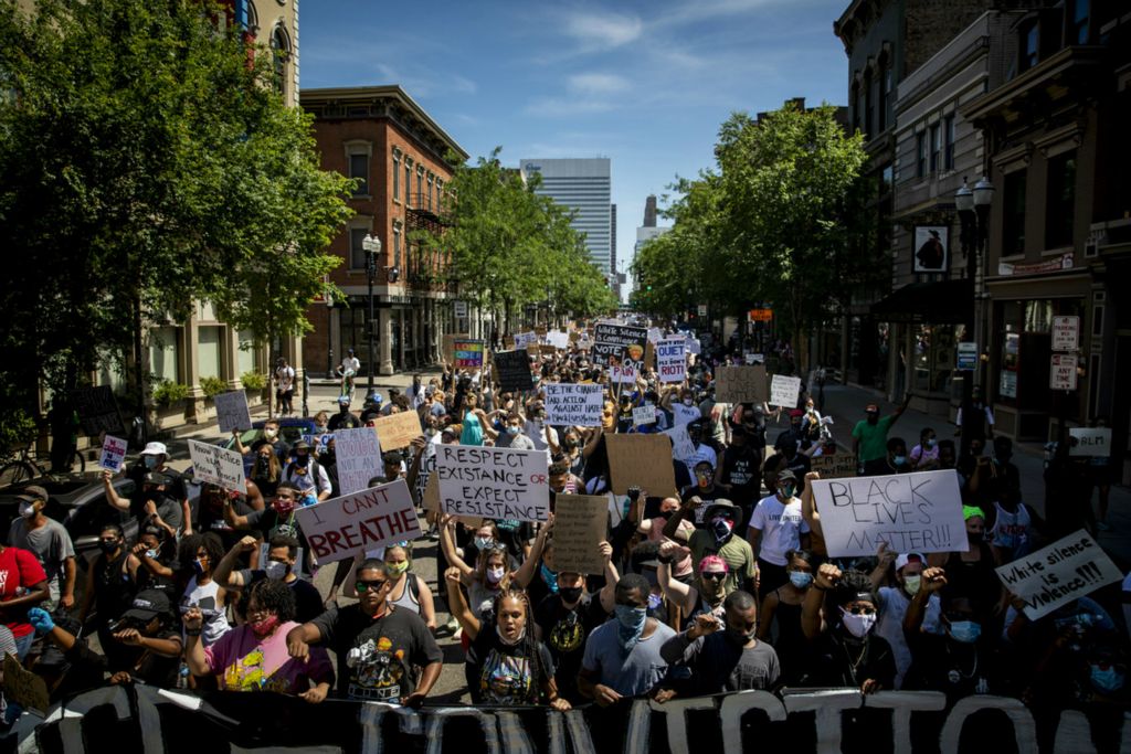 First Place, George S. Smallsreed Jr. Photographer of the Year - Large Market - Meg Vogel / The Cincinnati EnquirerThousands of protesters march north on Vine Street in Over-the-Rhine on Sunday, June 7, 2020. It was the tenth day of protests in response to the death of George Floyd in Minneapolis. Floyd died after being handcuffed and pinned to the ground by a police officer's knee. After George Floyd's death in late May, protests and civil unrest unfolded across the country. 
