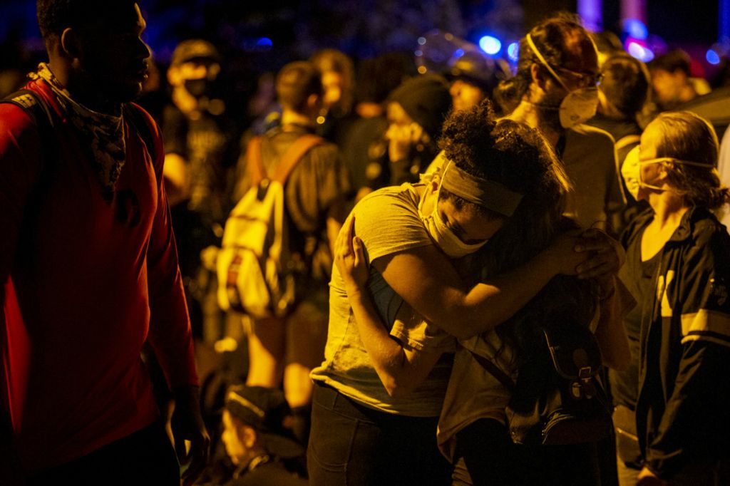 First Place, George S. Smallsreed Jr. Photographer of the Year - Large Market - Meg Vogel / The Cincinnati EnquirerProtesters embrace before being arrested on Green Street in Over-the-Rhine on Sunday, May 31, 2020. This is the third night of protests in response to the death of George Floyd in Minneapolis.
