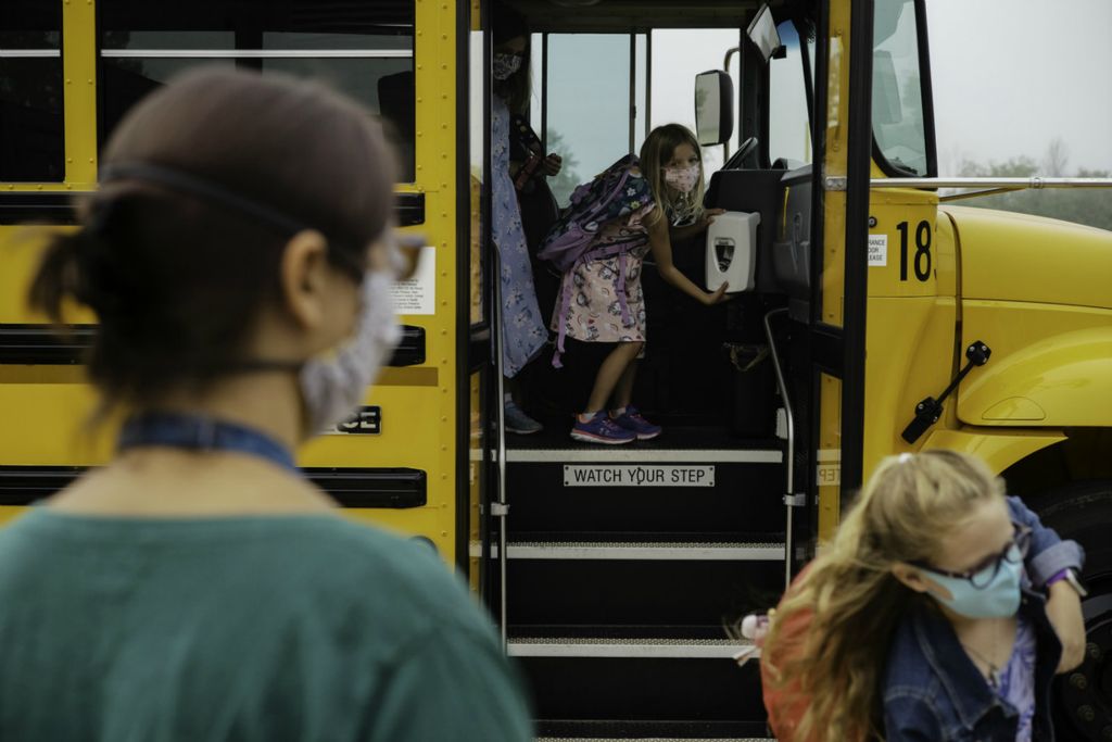 Second Place, George S. Smallsreed Jr. Photographer of the Year - Large Market - Joshua A. Bickel / The Columbus DispatchStudents get hand sanitizer as they step off the school bus during the first day of school on Tuesday, September 1, 2020 at Heritage Elementary School in Lewis Center, Ohio. The Olentangy School District is adopting a hybrid learning model during the COVID-19 pandemic, with half the students in school buildings part of the week, and at home the other half of the week.