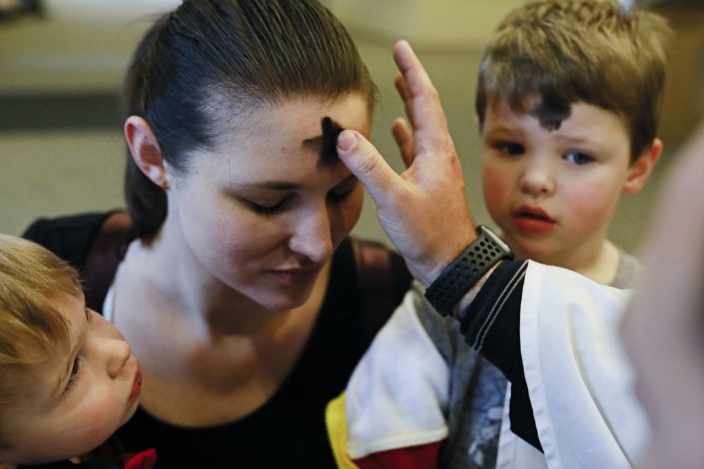 Second Place, George S. Smallsreed Jr. Photographer of the Year - Large Market - Joshua A. Bickel / The Columbus DispatchStacey Berling, center, of Grove City, kneels with her sons, Harrison, 2, left, and Finneus, 4, right, as she receives ashes from Deacon Andrew Ames Fuller during an Ash Wednesday service as part of "Ashes To Go" on Wednesday, February 26, 2020 at Upper Arlington Lutheran Church Mill Run Campus in Hilliard, Ohio. Worshippers were able to come to the church and either stay in their car or come inside the building lobby to receive their ashes in lieu of a formal mass or service. Ash Wednesday marks the beginning of the Christian season of Lent. 