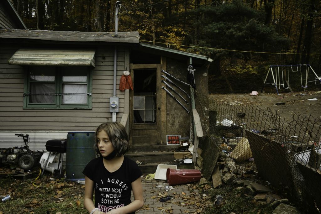 Second Place, George S. Smallsreed Jr. Photographer of the Year - Large Market - Joshua A. Bickel / The Columbus DispatchNine-year-old Brooklyn Spangler stands outside her home on Wednesday, Oct. 28, 2020 in Nelsonville, Ohio. Once a bustling 19th-century coal mining town, industry has come and gone from Nelsonville. Economic opportunities remain scant and 39% of its residents live in poverty. 