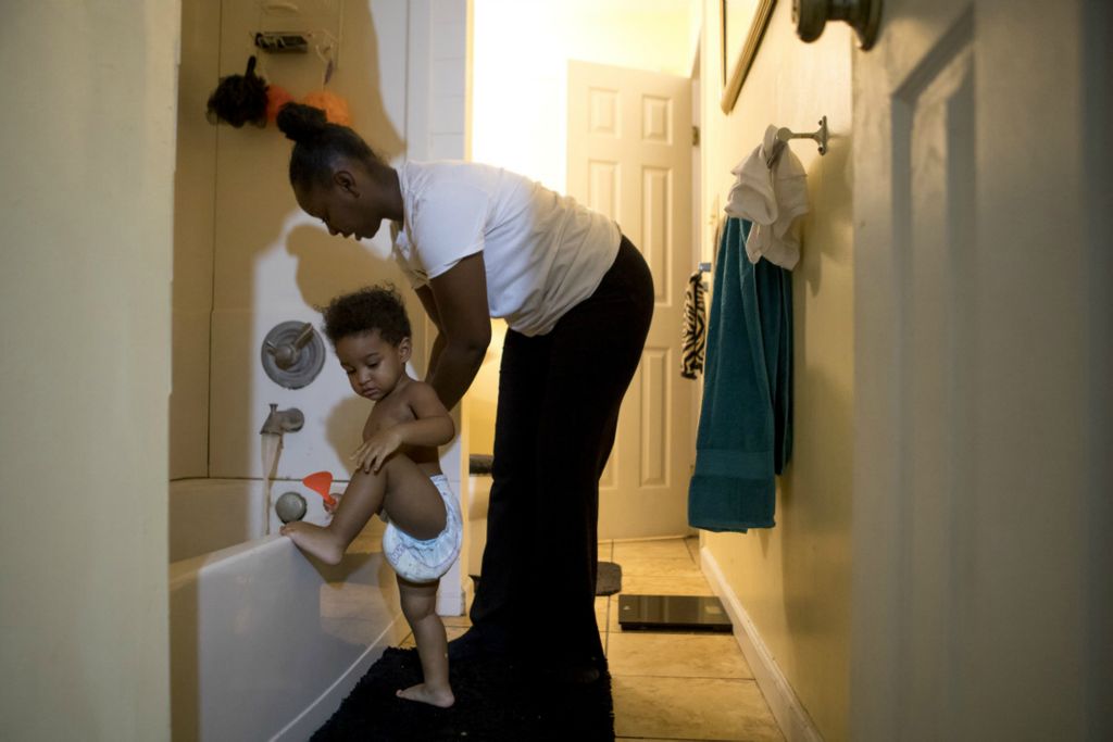 First Place, George S. Smallsreed Jr. Photographer of the Year - Small Market - Jessica Phelps / Newark AdvocateTashia Croom supports her 18 month old son Kendrix as he tries to climb into the bath tub. Tashia and her family have stayed in the Licking County area for 3 generations, building deep ties within the community. Tashia graduated from Heath high school, just as her mother, her sisters and in two years her daughter. The women all coach volleyball and basketball at the school.  