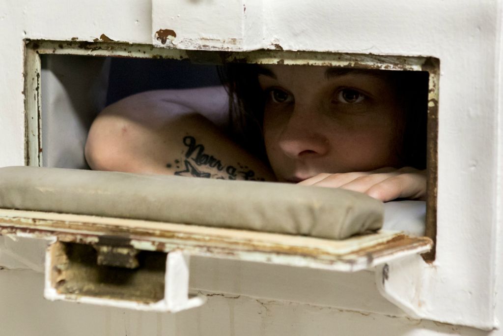 First Place, George S. Smallsreed Jr. Photographer of the Year - Small Market - Jessica Phelps / Newark AdvocateKassie Carpenter, 23, looks out from the padded cell listening to the general population at the Coshocton County Justice Center in November, 2020. Carpenter was arrested for felony possession of drugs and shortly after placed on suicide  watch and placed in the padded cell. Carpenter was hoping to be able to turn her life around but had a hard time dealing with the recent death of her mother which drove her to be placed on suicide watch and later taken to a psychiatric hospital. 