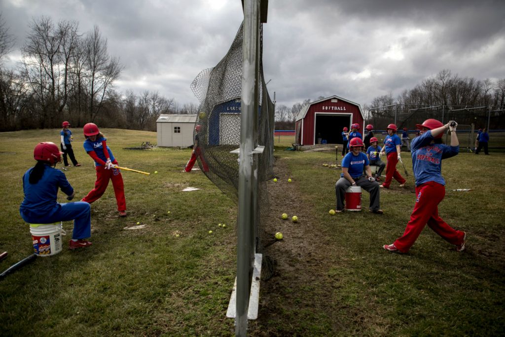 First Place, George S. Smallsreed Jr. Photographer of the Year - Small Market - Jessica Phelps / Newark AdvocateThe Lakewood softball team started the first days of their 2020 season with such optimism. They were favored to make a run for the state championship this year. But as the news started coming in about a potential pandemic players got nervous. When a shutdown was issued for schools in March the girls were devastated but kept their faith. They continued to practice at home. Alone. Finished their school work at home. Alone. And even graduate in an empty gym. They began to loose hope of having even a shortened season. Their coach knew the team, especially the seniors needed closure so he organized a senior night game pitting JV against varsity so the team could play on their home field in 2020.As winter turned to spring the Lakewood softball team began practice for their upcoming season March 11, 2020, yet unaware that the pandemic would hit canceling what was a highly anticipated season.