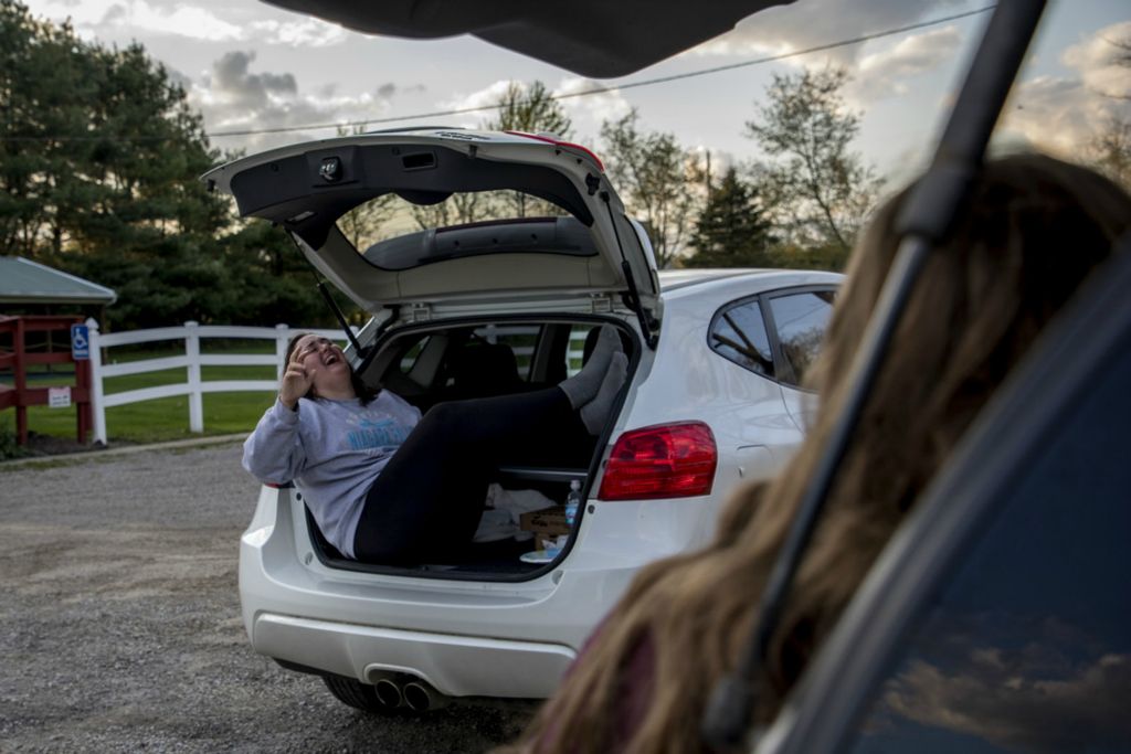 First Place, George S. Smallsreed Jr. Photographer of the Year - Small Market - Jessica Phelps / Newark AdvocateLakewood senior and third baseman, Kylah Morrison, laughs while visiting with friends May 7, 2020, during the shut down. She and her friends met in a parking lot and stayed in their cars to abide by social distancing guidelines, laughing and gossiping for hours.