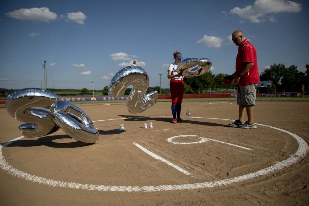 First Place, George S. Smallsreed Jr. Photographer of the Year - Small Market - Jessica Phelps / Newark AdvocateLakewood senior, Laila Schmitt wrestles with balloons that spell out 2020 for their senior night they had  June 30. Their season was canceled but OHSAA regulations allowed teams to cobble together a makeshift summer season to let kids play with their teams. Lakewood senior night was a family affair and saw the JV team take on varsity players.