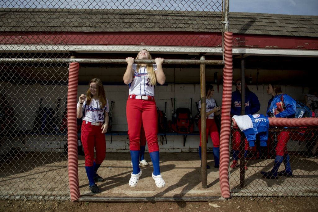 First Place, George S. Smallsreed Jr. Photographer of the Year - Small Market - Jessica Phelps / Newark AdvocateKatie Barton does pull-ups in the dugout after picture day, March 13. Lakewood coach Jon Griffith made sure the team got their picture taken before the shutdown began.