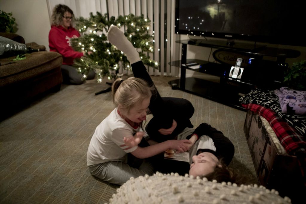 First Place, George S. Smallsreed Jr. Photographer of the Year - Small Market - Jessica Phelps / Newark AdvocateEnjoying the laughter of her two girls wrestling, Leah puts together the Christmas tree they then decorated together December 6, 2019. Leah kept her tree up for months after Christmas because she loved the lights so much. The family was also waiting for a big snow to celebrate a 'White Christmas' with her older children.