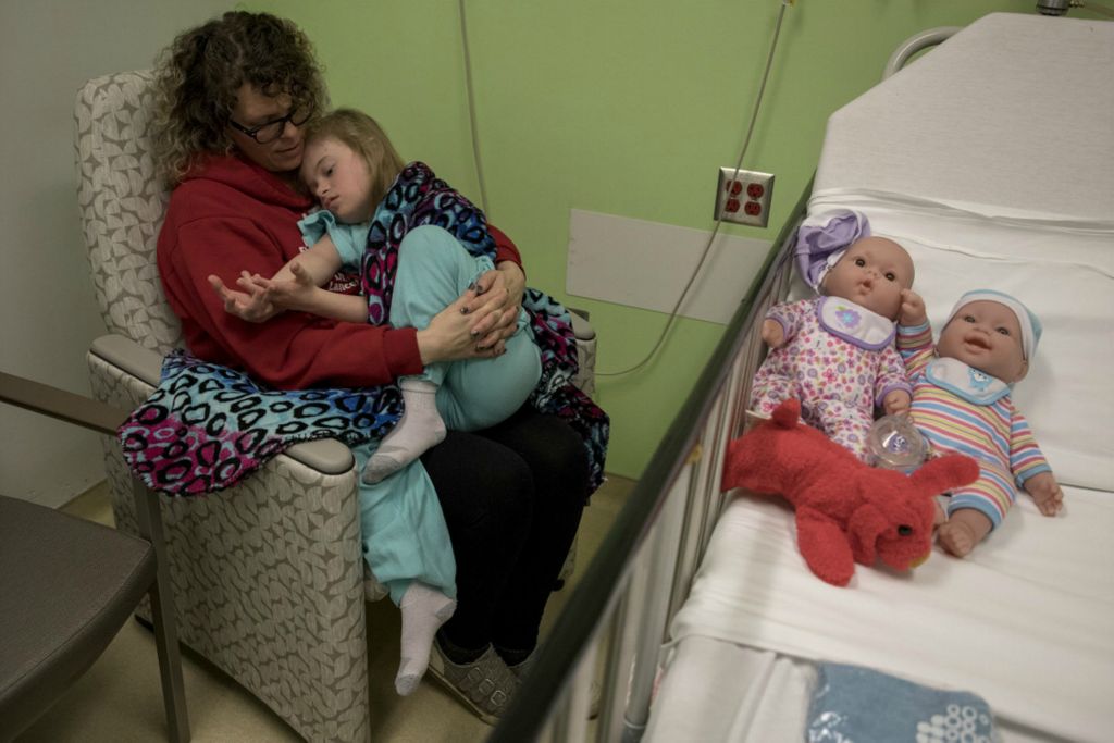 First Place, George S. Smallsreed Jr. Photographer of the Year - Small Market - Jessica Phelps / Newark AdvocateLeah Hrebluk holds her daughter, Kyndall close before she goes in for surgery at Nationwide Children's Hospital March 10, 2020. Kyndall had been having severe sinus infections, a symptom common for those with Down syndrome. The surgery was to help alleviate those symptoms by removing her tonsils. Kyndall's dolls, Baby Luke and Lucy Lu are on her hospital bed so she will have something familiar when she wakes up from the surgery.