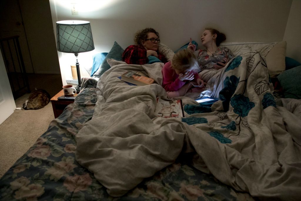 First Place, George S. Smallsreed Jr. Photographer of the Year - Small Market - Jessica Phelps / Newark AdvocateOn a chilly winter night Sophia and Kyndall both climbed into their mom, Leah Hrebluk's bed March 11, 2020. The trio are extremely close and do everything together. 