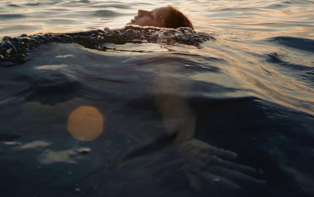 First Place, Portrait Personality - Madeleine Hordinski / Ohio University, “Sabina”My family drove up to Michigan after the school year ended to stay for a week in a small cabin. It’s very isolated, so it was the only place we felt comfortable going as a family during the pandemic. Here, my sister Sabina swims in Torch Lake, MI, on July 25, 2020. All of her friends will be attending different schools, so she’s been having trouble navigating these relationships and the next steps she needs to make before moving forward. Several of her friends will be moving out of state. Just like Sabina, I’m not sure of what’s next. But, I’m grateful to be surrounded by my loving family; that’s the silver lining in all of this. 