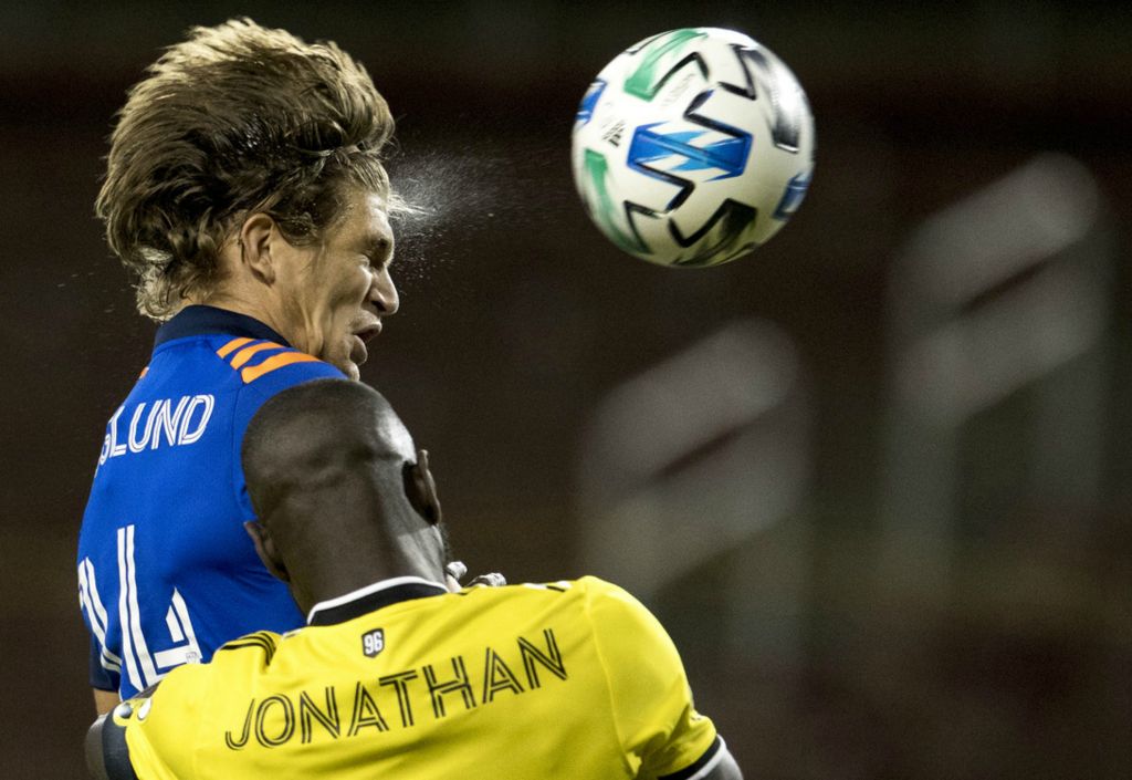 Third Place, Sports Action - Albert Cesare / The Cincinnati Enquirer, “Head On”FC Cincinnati defender Nick Hagglund (14) heads a shot just over the goal as Columbus Crew defender Jonathan Mensah (4) guards him in the first half of the MLS match on Oct. 14, 2020, in Cincinnati. 