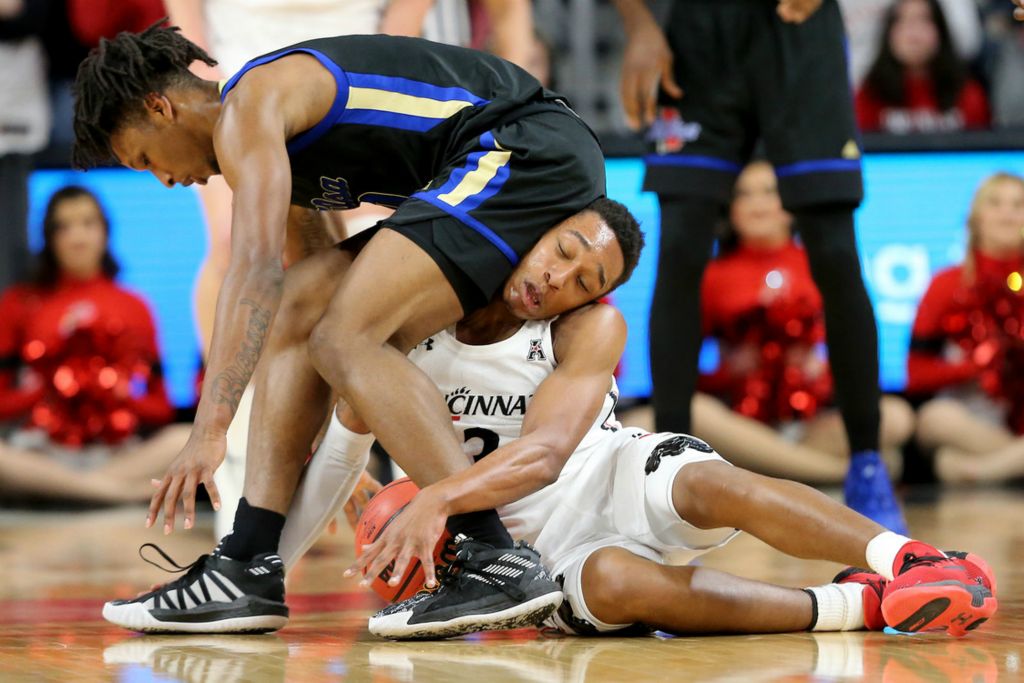 First Place, Sports Action - Kareem Elgazzar / The Cincinnati Enquirer, “Crunch”Tulsa Golden center Emmanuel Ugboh (left) and Cincinnati guard Mika Adams-Woods compete for a loose ball during the first half of a game Jan. 8, 2020, at Fifth Third Arena in Cincinnati. 