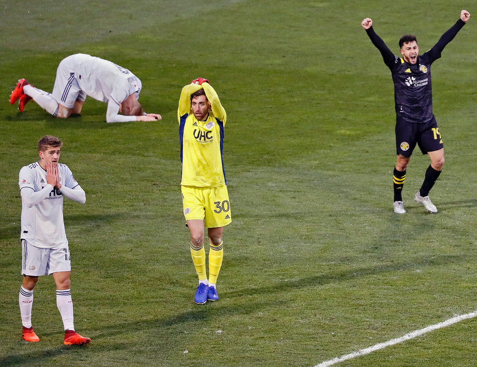 Second Place, Sports Feature - Kyle Robertson / The Columbus Dispatch, “Champs”Columbus Crew SC defender Milton Valenzuela (19) and midfielder Ema Boateng (20) celebrate after beating New England Revolution 1-0 in the MLS Eastern Conference Final at MAPFRE Stadium in Columbus on December 6, 2020. 