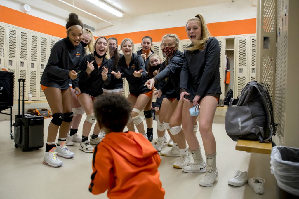 First Place, Ron Kuntz Sports Photographer of the Year - Jessica Phelps / Newark AdvocateThe Heath volleyball team dance with their coach's son, Kendrix while getting pumped up for their home game against Zanesville on October 15, 2020. Heath swept the match 3-0. 