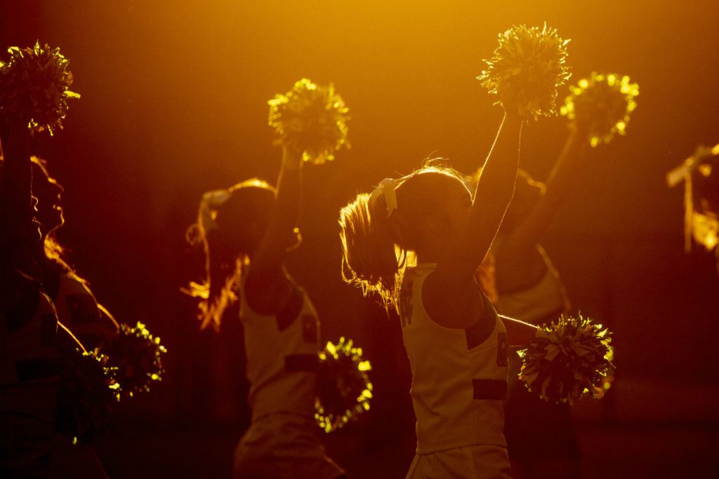 First Place, Ron Kuntz Sports Photographer of the Year - Jessica Phelps / Newark AdvocateNewark Catholic cheerleaders warm up the crowd in as the sunsets over White Field, September 5, 2020. 