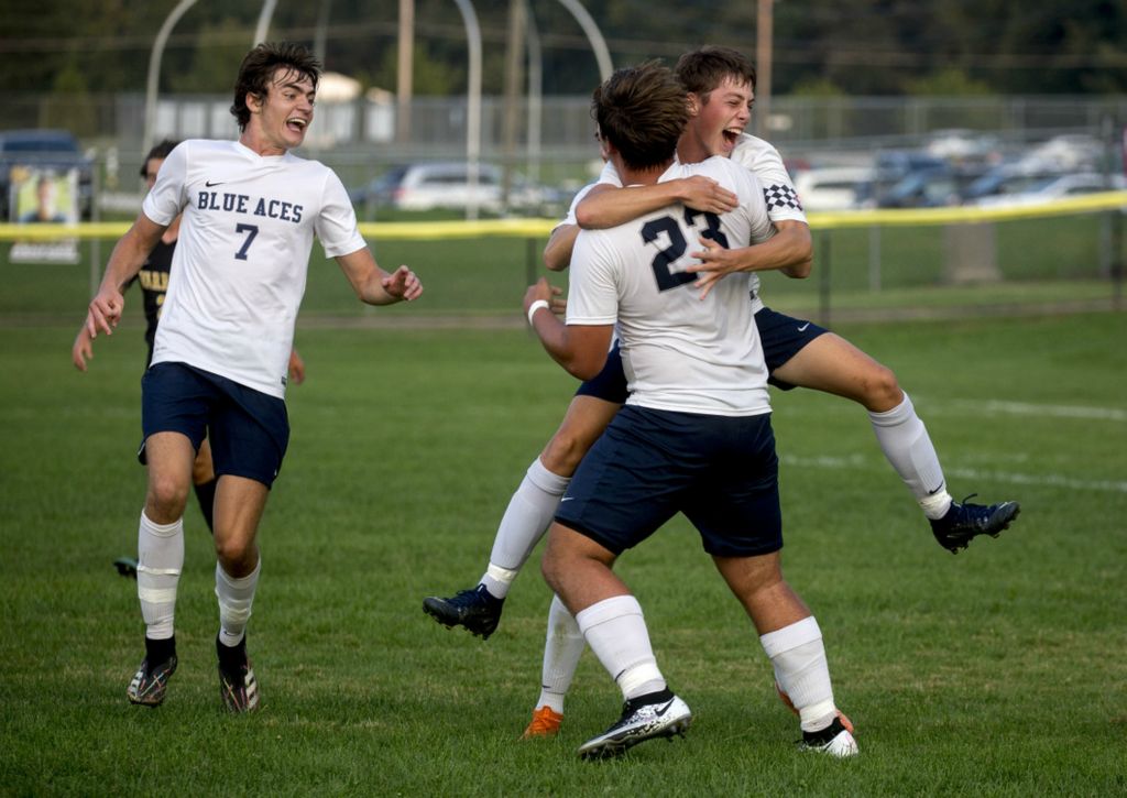 First Place, Ron Kuntz Sports Photographer of the Year - Jessica Phelps / Newark AdvocateGranville seniors Ian White and Max King (7) celebrate with classmate Julian Labocki, after he scored the second goal in a Licking County League game against host Watkins Memorial on Thursday September 9, 2020. The unbeaten Blue Aces won 3-0.