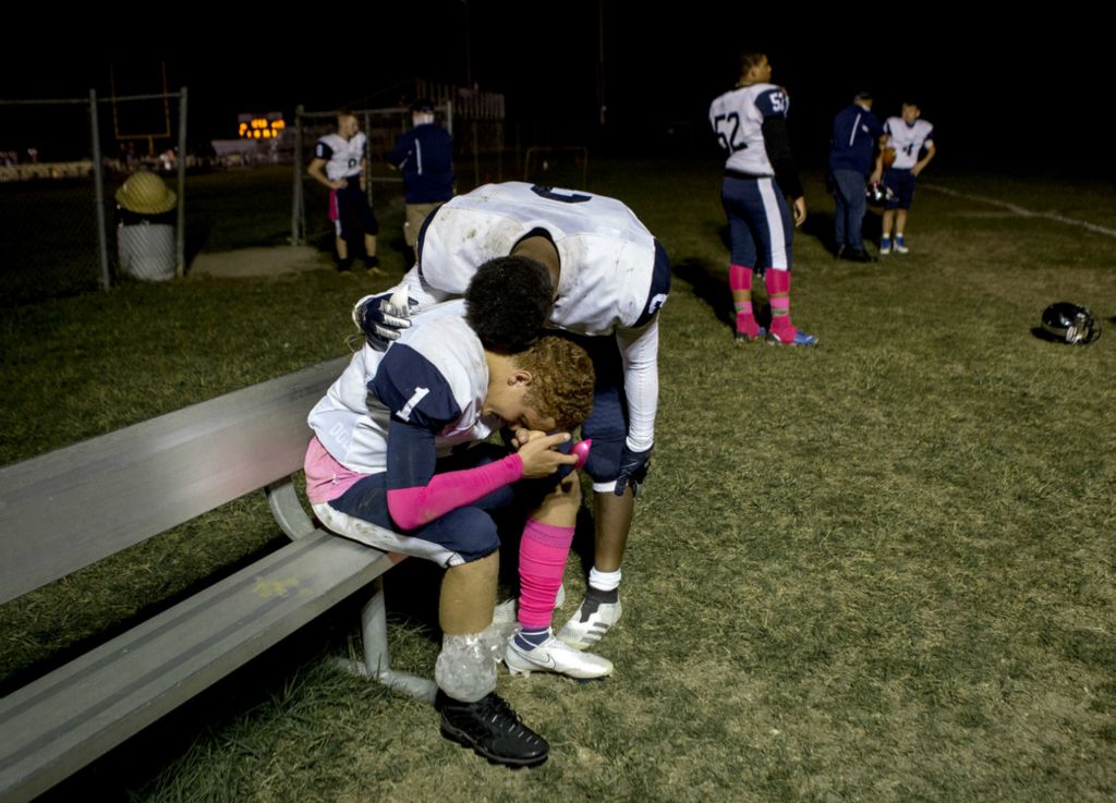 First Place, Ron Kuntz Sports Photographer of the Year - Jessica Phelps / Newark AdvocateWhetstone senior quarterback, Alex Hurd, is comforted by a teammate during halftime of the school's first playoff game in school history on October 9, 2020. Hurd who was injured in the second quarter had to watch his team loose his final game of his high school career. Whetstone lost to Licking Heights, 28-9. 