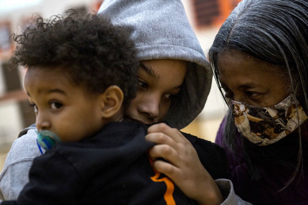 First Place, Ron Kuntz Sports Photographer of the Year - Jessica Phelps / Newark AdvocateTaliyah Holmes holds her baby brother, Kendrix while her great-grandmother, Rubbie Stinson comes over to congratulate her on her first basketball of the season, November 21, 2020. Ruby, who is the matriarch of the family raised 6 children by herself in the Heath area. Ruby is the reason the entire extended family is always there to support each other whether at  children games or through the tough times. She is the reason all the women in the family have so much inner strength and self confidence. The roots Ruby established in the area is also a large part of why this Black family has choses to stay in a largely white, conservative area when so many other Black families have left. 