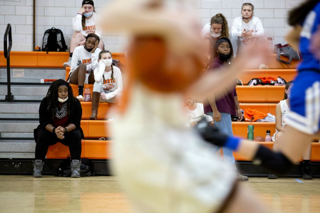 First Place, Ron Kuntz Sports Photographer of the Year - Jessica Phelps / Newark AdvocateSisters Tavia Croom (right) and her sister, Taya Croom, (left) cheer on the Heath 7th grade girls basketball team December 10, 2020. Both sisters coach the middle school teams while their older sister and mom coach high school volleyball in the fall. The tight knit family had developed deep roots in Heath as well as with each other, keeping them tied to an area that many Black families leave after a few years. 