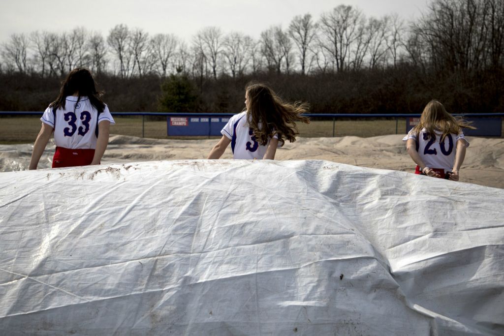 First Place, Ron Kuntz Sports Photographer of the Year - Jessica Phelps / Newark AdvocateLakewood players uncover the field for the last time before the shutdown began March 13 2020. At the time there were so many uncertainties and the girls were all holding out hope they would only be out three weeks of their season.