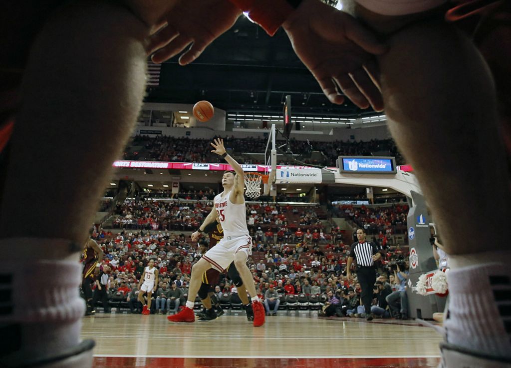 Second Place, Ron Kuntz Sports Photographer of the Year - Kyle Robertson / The Columbus DispatchOhio State Buckeyes forward Kyle Young (25) posts up Minnesota Golden Gophers guard Tre' Williams (1) during the 2nd half of their game at Value City Arena in Columbus, Ohio on January 23, 2020. 