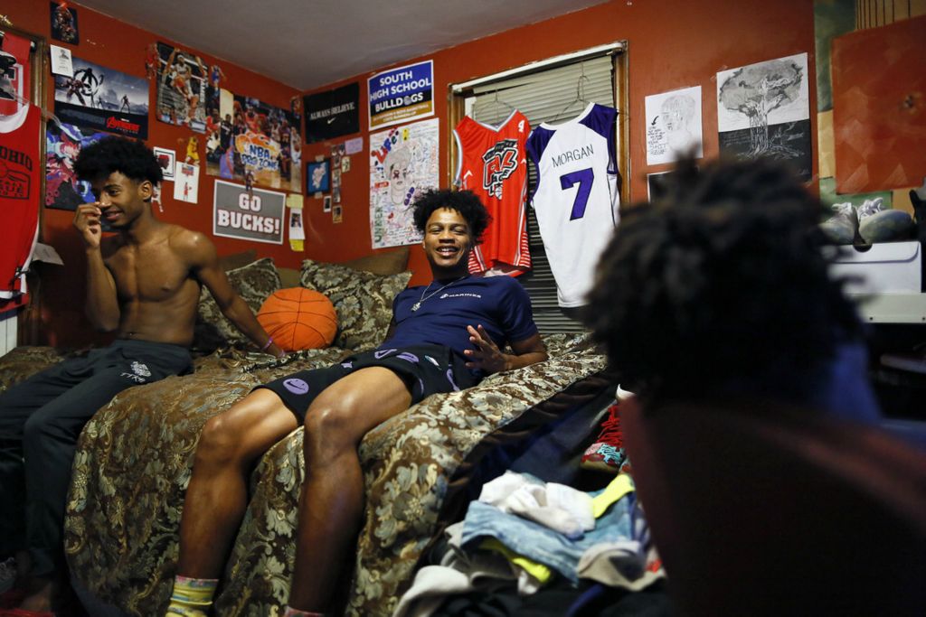 Second Place, Ron Kuntz Sports Photographer of the Year - Kyle Robertson / The Columbus DispatchTrevell Adams, center, talks about NBA basketball teams with teammates Chaz Thomas, left, and Kashawn Simington, right, at Trevell's house in Columbus on November 9, 2019.  The three teammates always hang out after basketball practice.