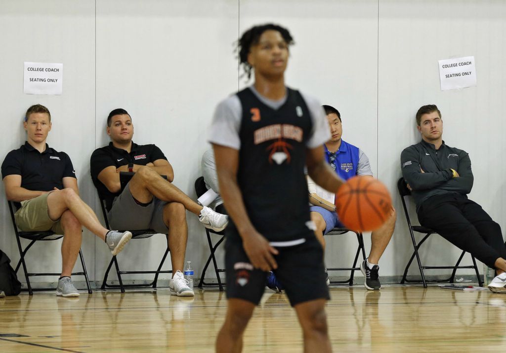 Second Place, Ron Kuntz Sports Photographer of the Year - Kyle Robertson / The Columbus DispatchHidden Gems Trevell Adams dribbles the ball up court as college basketball coaches watch during the Gym Rats Basketball Association Nationals at the Sport One/Parkview Fieldhouse in Fort Wayne, Indiana on July 27, 2019.  Trevell and Hidden Gems won the Silver Championship. 